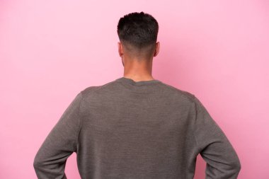 Kafkasyalı genç bir adam pembe arka planda izole edilmiş.