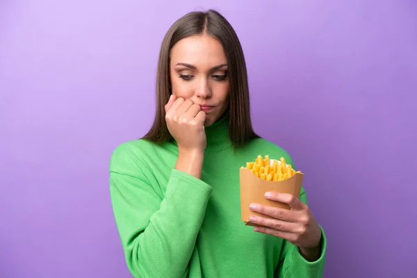 Young Caucasian Woman Holding Fried Chips Purple Background Having Doubts — Stock Photo, Image