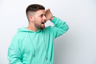 Beyaz arka planda beyaz tenli genç bir adam sürpriz bir ifadeyle yan yana bakarken...