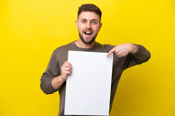 Young Caucasian Man Isolated Yellow Background Holding Empty Placard Happy — Stock Photo, Image