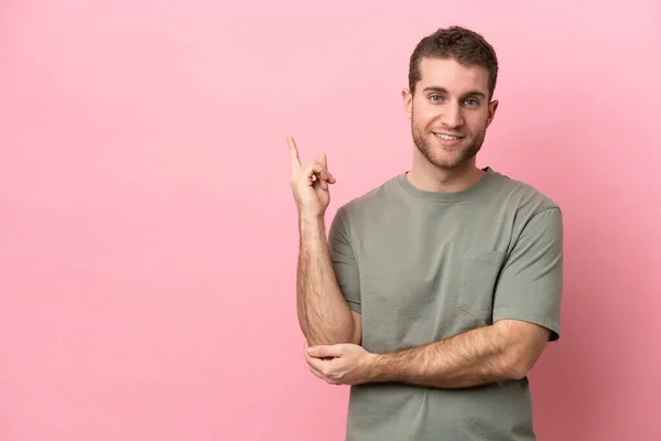 Young Caucasian Man Isolated Pink Background Happy Pointing — Stock Photo, Image