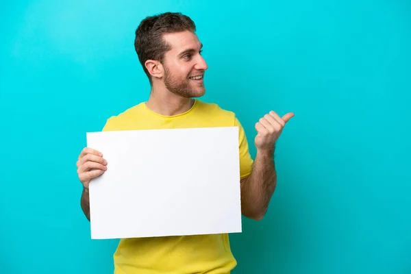 Young Caucasian Man Isolated Blue Background Holding Empty Placard Pointing — Stock Photo, Image