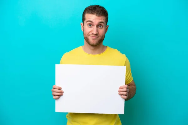 Young Caucasian Man Isolated Blue Background Holding Empty Placard — Stock Photo, Image