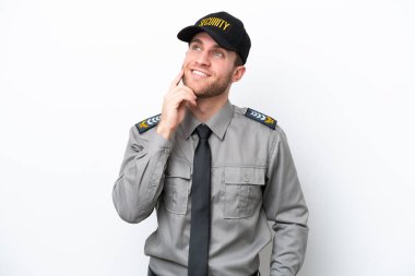 Beyaz arka planda izole edilmiş genç bir güvenlik görevlisi yukarı bakarken bir fikir düşünüyor.