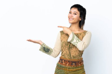 İzole edilmiş beyaz arkaplan üzerinde genç Uruguaylı kız bir ilan vermek için avucunun içinde hayali bir metin tutuyor.