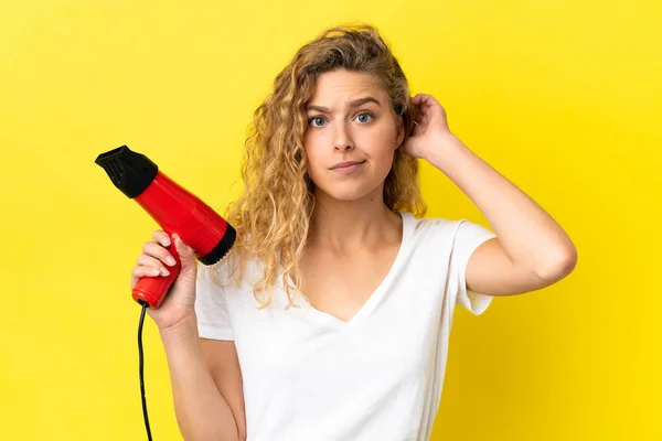 Jonge Blonde Vrouw Met Een Haardroger Geïsoleerd Gele Achtergrond Met — Stockfoto