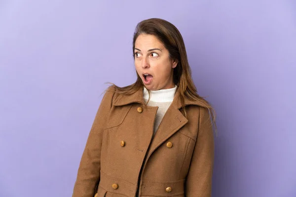 Middle Age Brazilian Woman Isolated Purple Background Doing Surprise Gesture — Stock Photo, Image