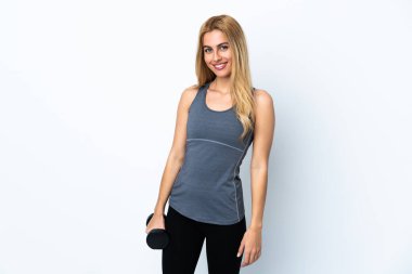 Genç sarışın spor kadın izole edilmiş mor arka planda ağırlık kaldırıyor.