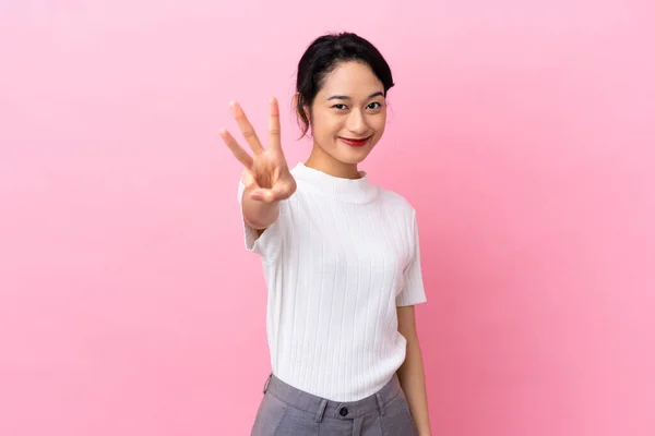Joven Vietnamita Aislada Sobre Fondo Rosa Feliz Contando Tres Con —  Fotos de Stock