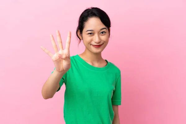 若いですベトナム人女性隔離上のピンクの背景幸せとカウント4とともに指 — ストック写真