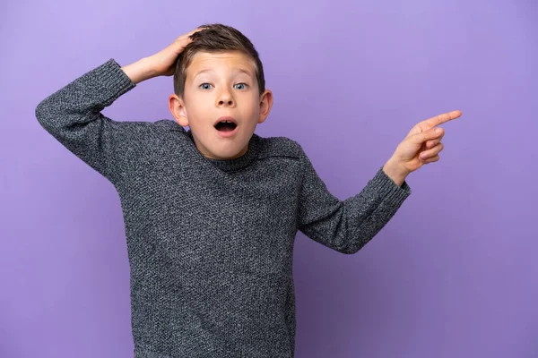 Niño Aislado Sobre Fondo Púrpura Sorprendido Señalando Dedo Hacia Lado —  Fotos de Stock