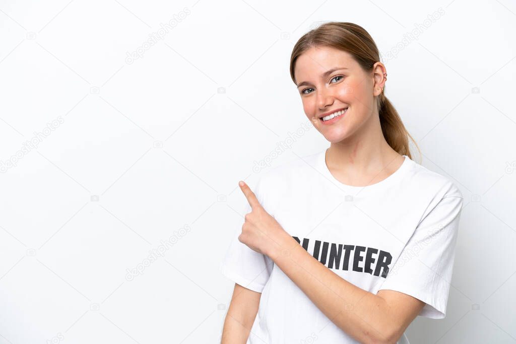 Young volunteer woman isolated on white background pointing to the side to present a product