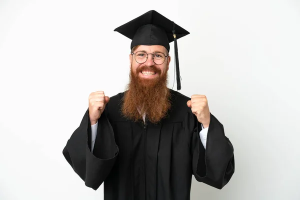 Jovem Universitário Graduado Homem Avermelhado Isolado Fundo Branco Comemorando Uma — Fotografia de Stock