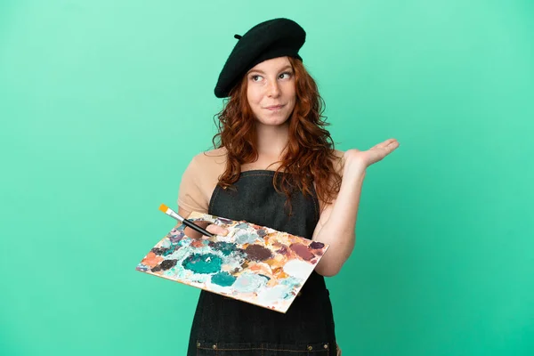 Teenager Redhead Artist Holding Palette Isolated Green Background Having Doubts — Stock Photo, Image