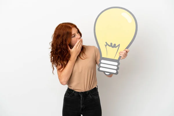 Teenager Redhead Girl Isolated White Background Holding Bulb Icon Surprised — Stock Photo, Image