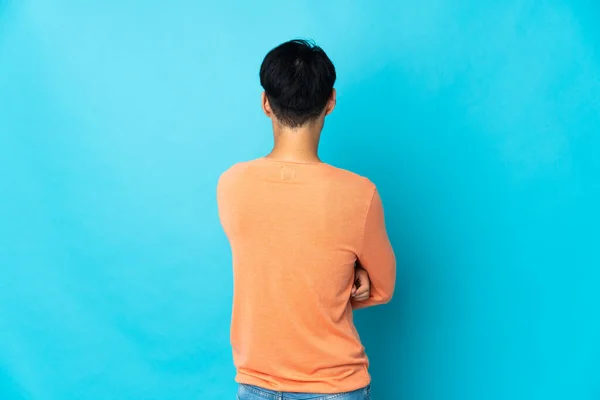 Young Chinese Man Isolated Blue Background Back Position — Stock Photo, Image
