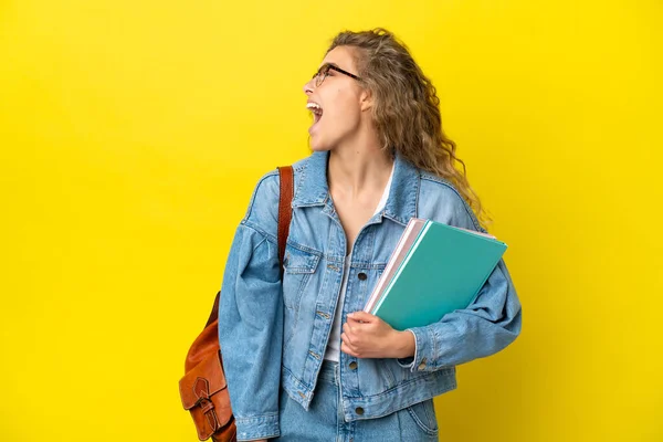 Young Student Caucasian Woman Isolated Yellow Background Laughing Lateral Position — Stock Photo, Image