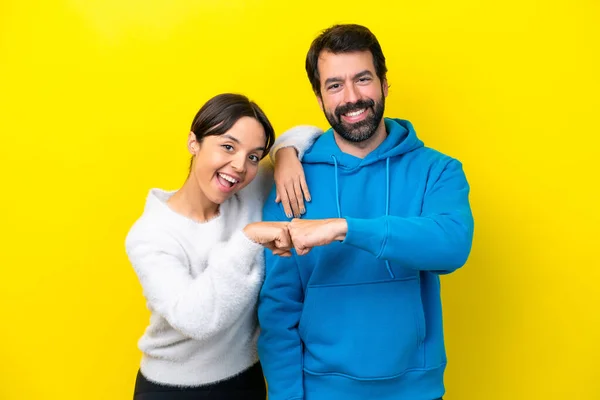 Young Caucasian Couple Isolated Yellow Background Bumping Fists — Stock fotografie