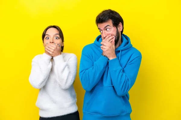 Young Caucasian Couple Isolated Yellow Background Covering Mouth Hands —  Fotos de Stock