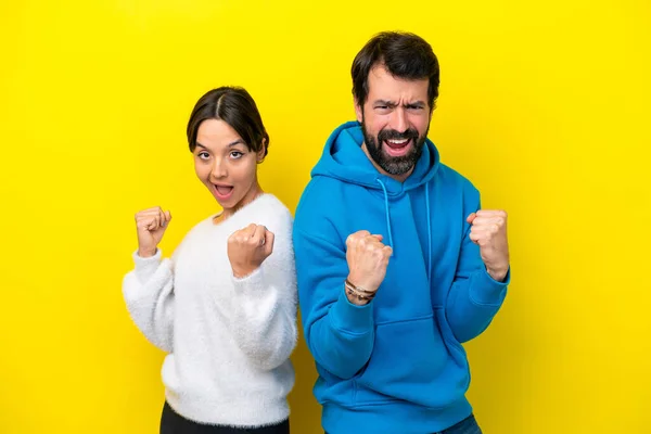 Young Caucasian Couple Isolated Yellow Background Celebrating Victory Winner Position — Foto Stock