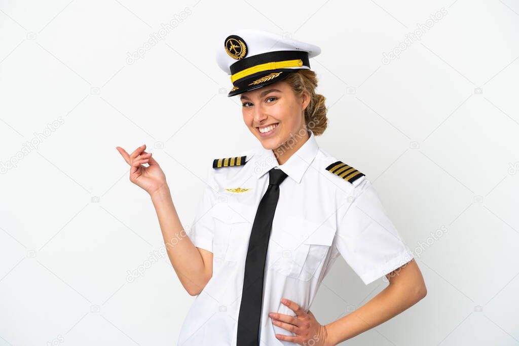 Airplane blonde woman pilot isolated on white background pointing finger to the side