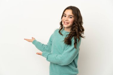 Beyaz arka planda izole edilmiş küçük beyaz kız, davet edilmek için ellerini yana uzatıyor.