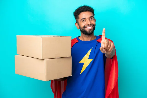 Super Hero Delivery Brazilian Man Isolated Blue Background Showing Lifting — Stock Photo, Image