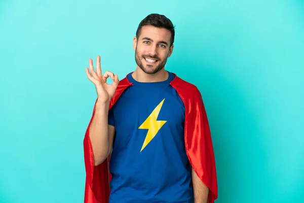 Super Hero Biały Człowiek Odizolowany Niebieskim Tle Pokazuje Znak Palcami — Zdjęcie stockowe