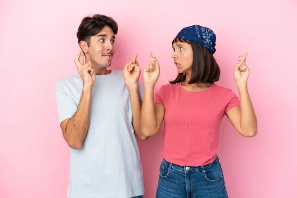 Young Couple Isolated Pink Background Fingers Crossing Wishing Best — Stock Photo, Image