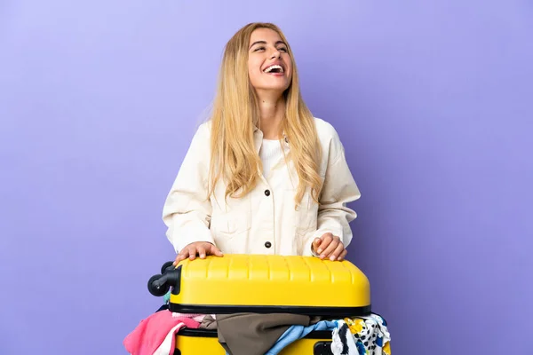 Young Uruguayan Blonde Woman Suitcase Full Clothes Isolated Purple Wall — Stock Photo, Image