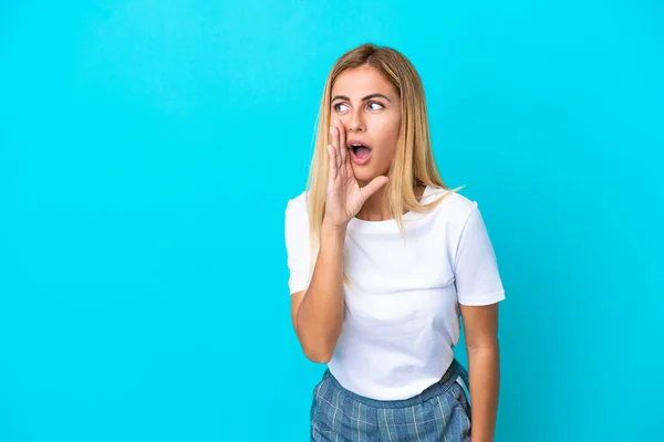 Blonde Uruguayan Girl Isolated Blue Background Whispering Something Surprise Gesture — Stock Photo, Image