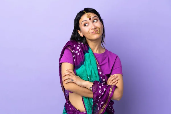 Indian Woman Isolated Purple Background Making Doubts Gesture While Lifting — Stock Photo, Image