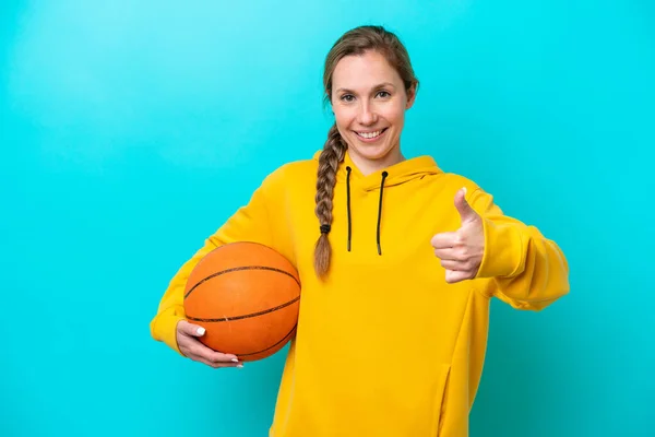 코카서스 여성은 파란색 배경에 고립되어 농구를 엄지손가락을 올리고 — 스톡 사진