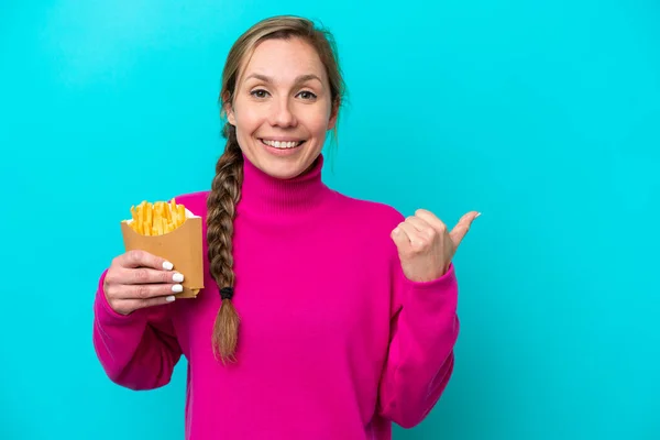 Young Caucasian Woman Holding Fried Chips Isolated Blue Background Pointing — Foto Stock