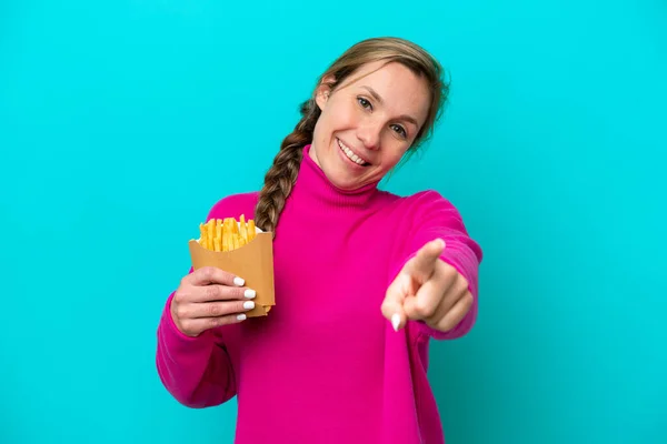 Young Caucasian Woman Holding Fried Chips Isolated Blue Background Pointing —  Fotos de Stock