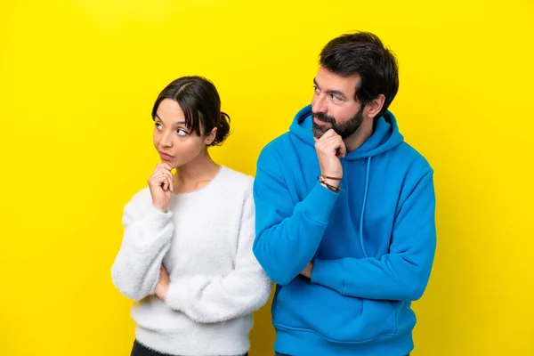 Young Caucasian Couple Isolated Yellow Background Looking Side — Stock Fotó