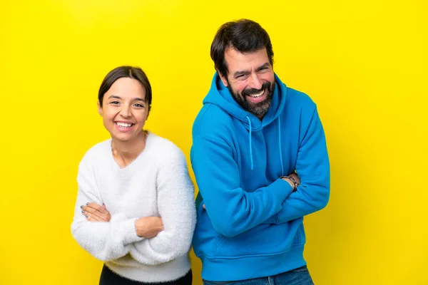 Young Caucasian Couple Isolated Yellow Background Keeping Arms Crossed While — Stock fotografie