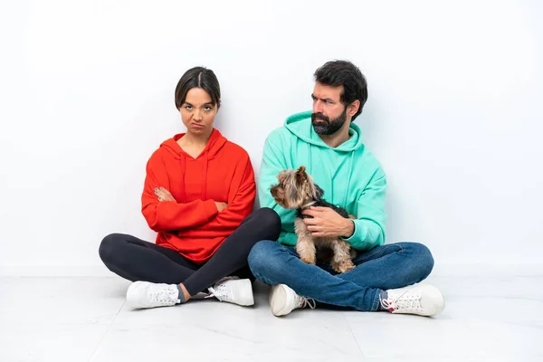 Young Caucasian Couple Sitting Floor Pet Isolated White Background Annoyed — Stock Fotó