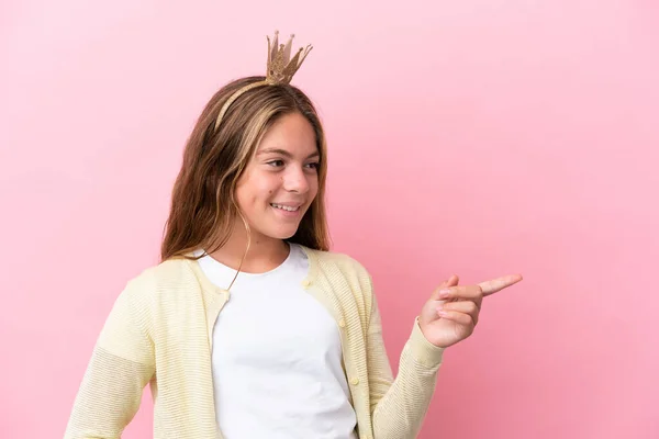 Little Princess Crown Isolated Pink Background Pointing Finger Side Presenting — стоковое фото