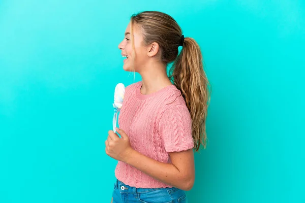 Little Caucasian Girl Holding Lollipop Isolated Blue Background Laughing Lateral — Stock Fotó