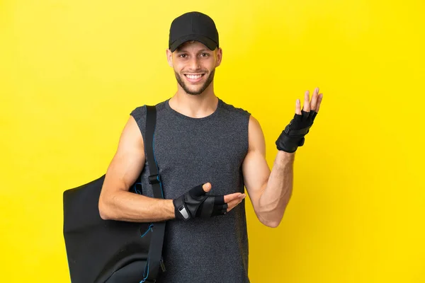 Young Sport Blonde Man Sport Bag Isolated Yellow Background Extending — Stockfoto