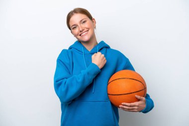 Beyazların arka planında izole edilmiş basketbol oynayan beyaz bir kadın zaferi kutluyor.