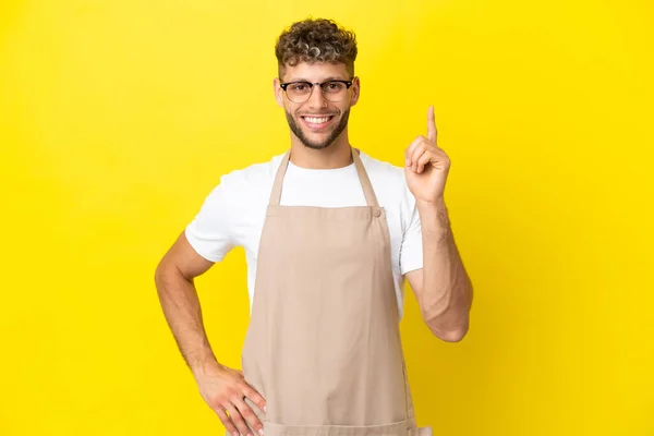 Restaurant Waiter Blonde Man Isolated Yellow Background Showing Lifting Finger — kuvapankkivalokuva