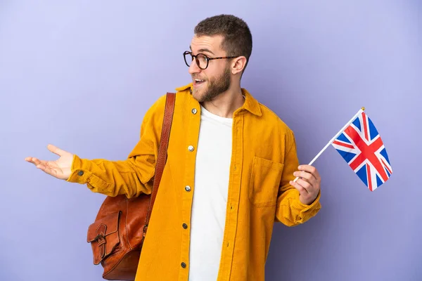 Young Caucasian Man Holding United Kingdom Flag Isolated Purple Background — 스톡 사진