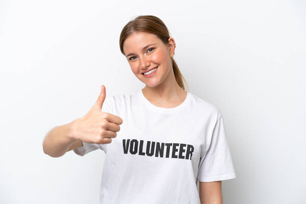 Young volunteer woman isolated on white background with thumbs up because something good has happened