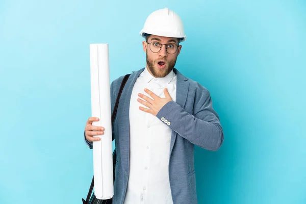 Young Architect Man Helmet Holding Blueprints Isolated Background Surprised Shocked — 스톡 사진