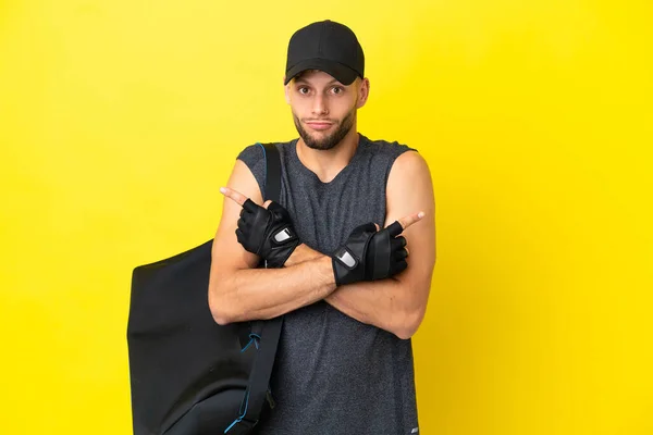 Young Sport Blonde Man Sport Bag Isolated Yellow Background Pointing — 스톡 사진