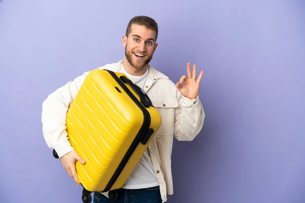 Young Handsome Caucasian Man Isolated Purple Background Vacation Travel Suitcase — Stock fotografie