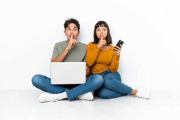 Young Couple Laptop Mobile Sitting Floor Showing Sign Silence Gesture — 图库照片