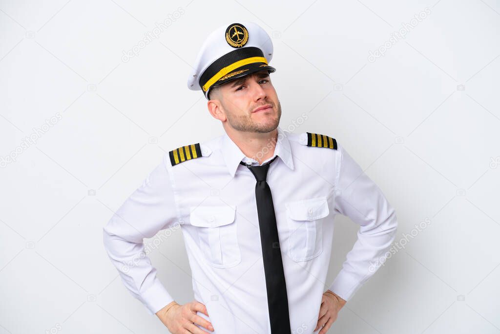 Airplane caucasian pilot isolated on white background suffering from backache for having made an effort